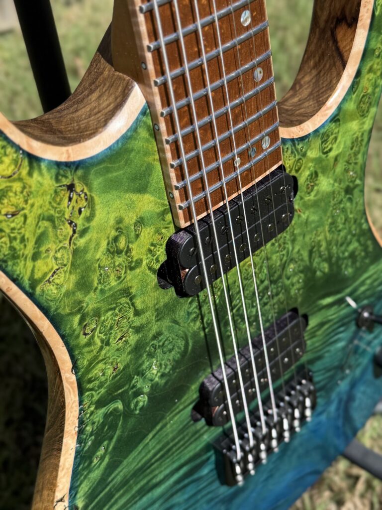 Blue-green burl top detail on a T.W. Smith Apex 7 guitar