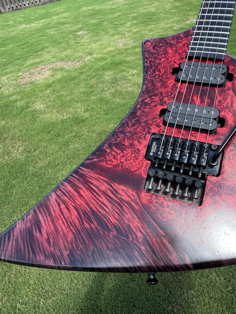 Red burl top wood detail on a T.W. Smith Arch 6 guitar