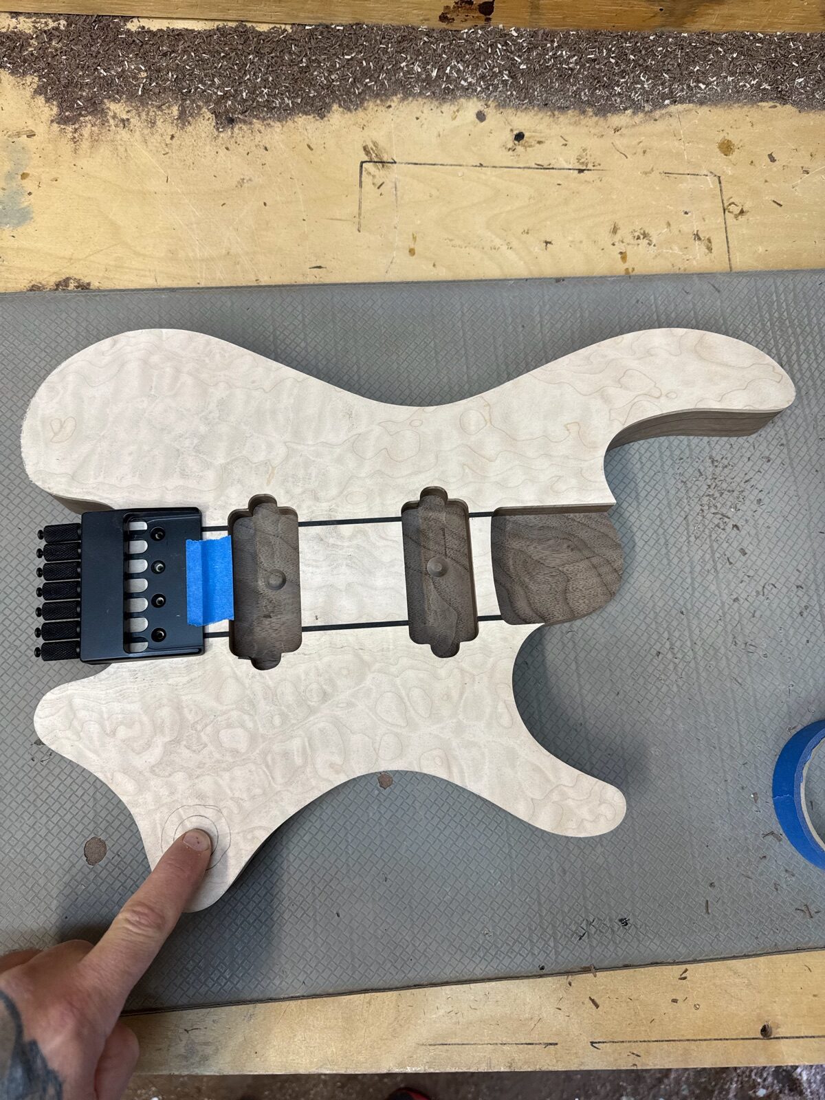 Quilted maple guitar body with hardware mocked up during a custom build