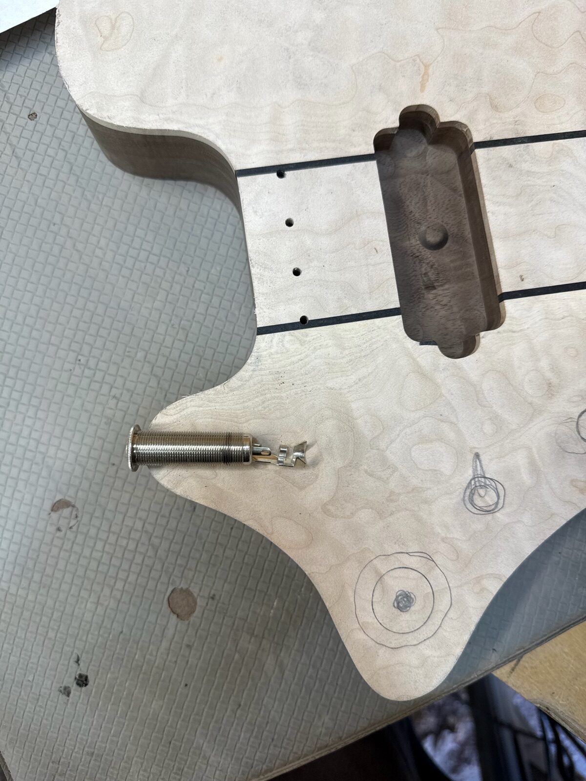Custom guitar body and neck in progress on the workbench