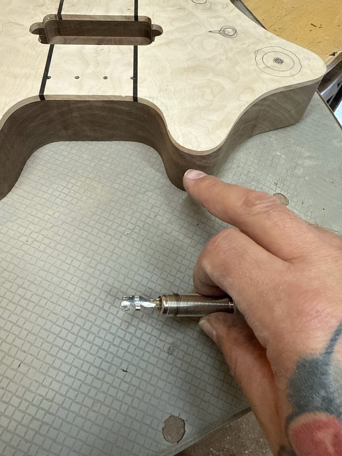 Luthier hand-assembling a custom guitar at the bench