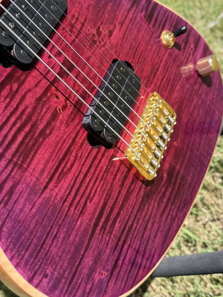 Purple-red flame maple top detail on a T.W. Smith Gordon 7 guitar