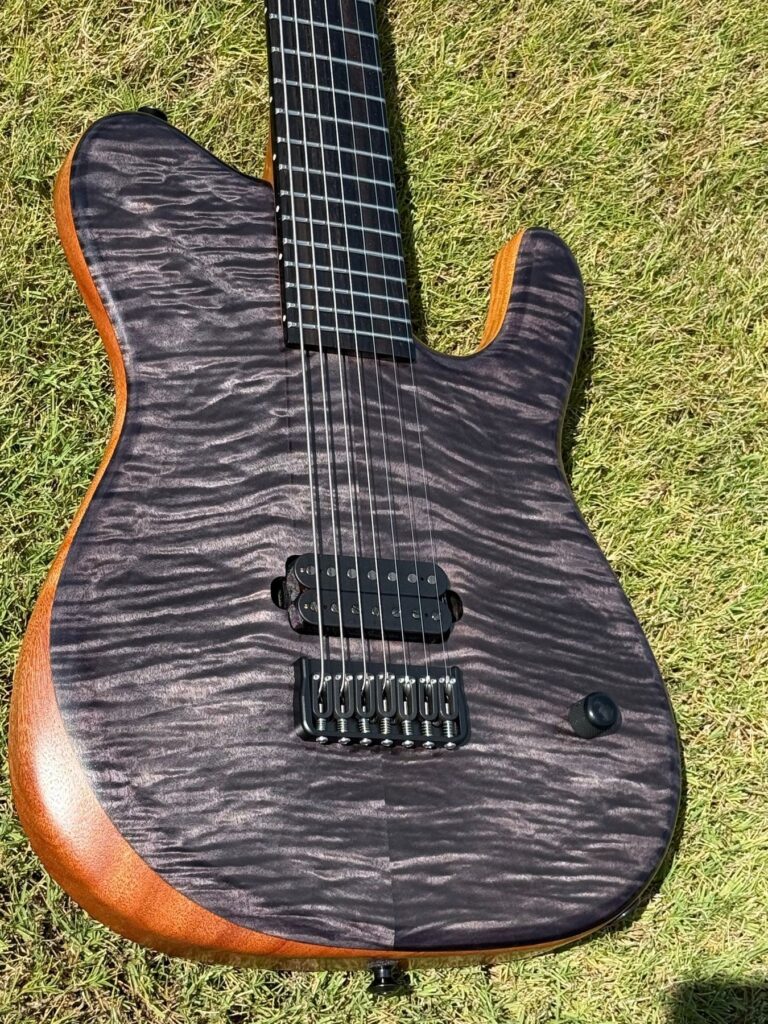 Black flame maple top detail on a T.W. Smith Talia 7 guitar
