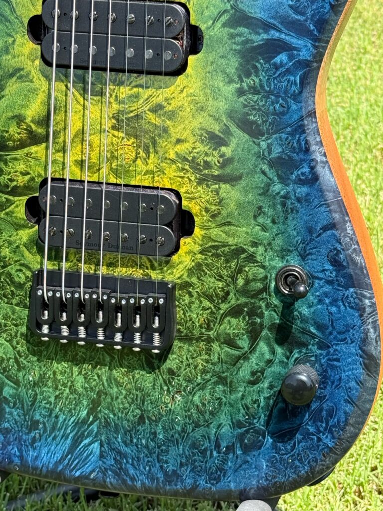 Yellow, green and blue burl top and hardware detail on a completed T.W. Smith Apex 7 guitar