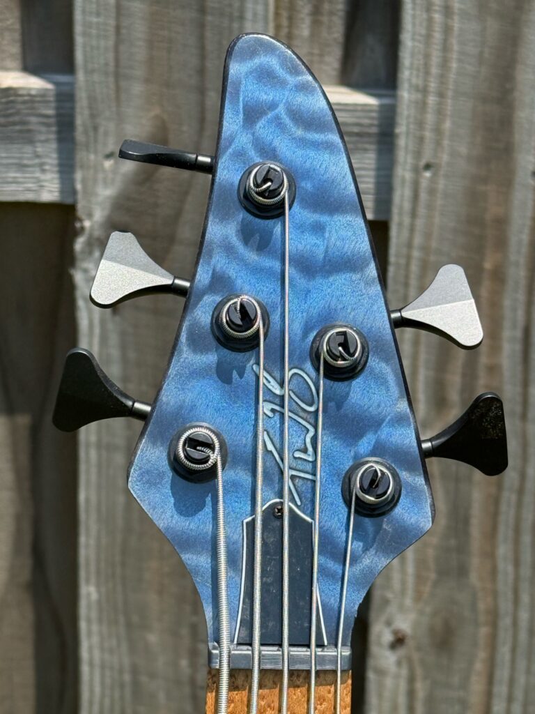Blue quilted maple headstock detail on a completed T.W. Smith Gordon 5-string bass