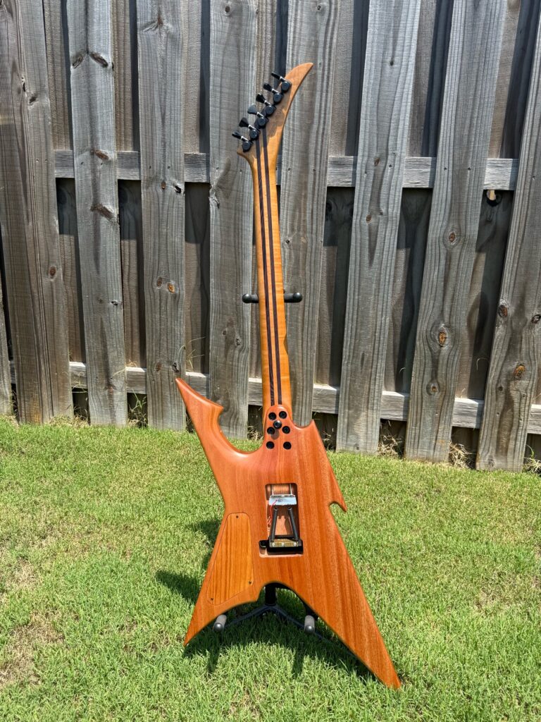 Back view of a completed T.W. Smith Vulture 7 custom guitar with walnut burl top